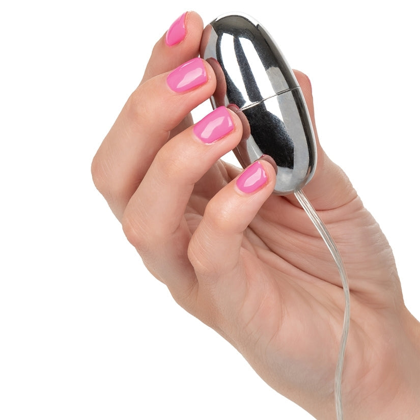 Hand holding a small electronic device with a white background