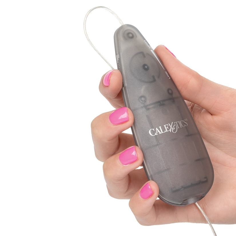 Hand holding a gray electronic device with 'CALEXOTICS' branding on a white background