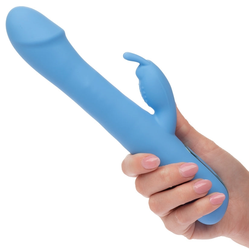 Blue silicone wand held by a hand on a white background