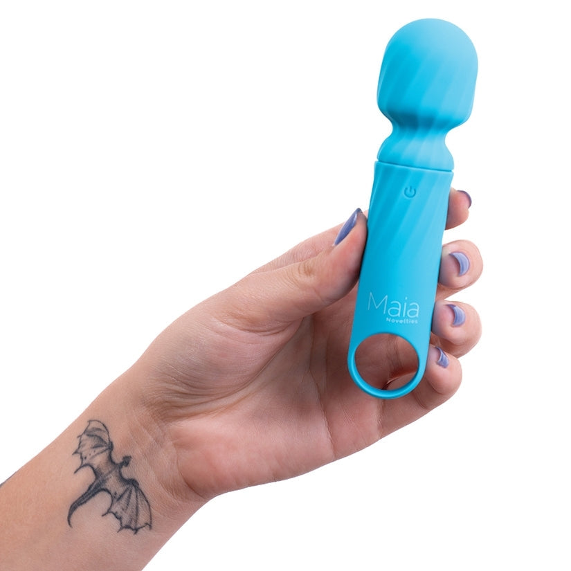 Hand holding a blue device labeled 'Maia' against a white background