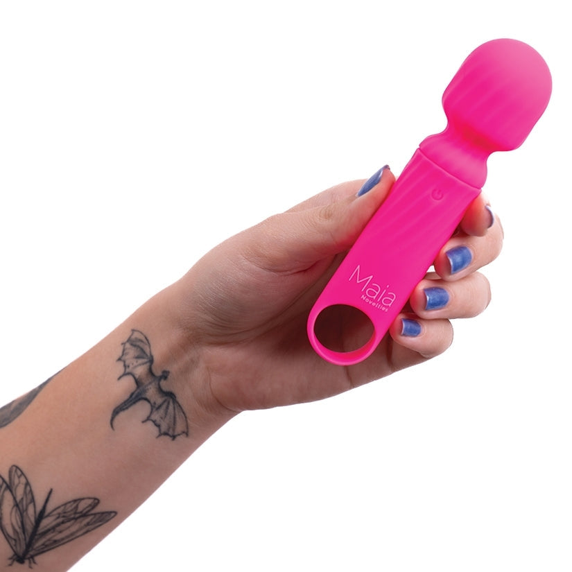 Hand holding a pink tool with 'Mala' branding on a white background