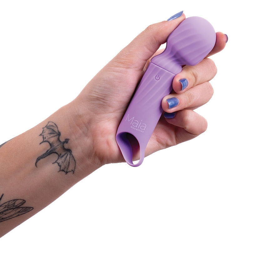 Hand holding a purple tool with 'Maia' branding on a white background