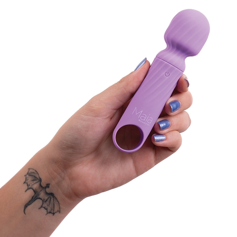 Hand holding a purple tool with 'Maia' branding on a white background