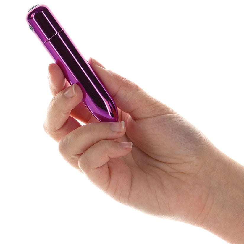 Hand holding a purple electronic device on a white background