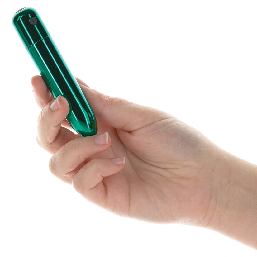 Hand holding a green pen-like object against a white background